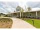Community clubhouse featuring an outdoor area with a walkway, green lawn, and beautiful landscaping at 170 Collared Dove Ct, Summerville, SC 29483