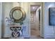 Hallway with tile floors, decorative wall mirror, and entry to another room with stairway at 170 Collared Dove Ct, Summerville, SC 29483