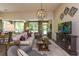 Living room featuring neutral color sofa, hardwood floors, modern lighting fixture, and decorative wall accents at 170 Collared Dove Ct, Summerville, SC 29483