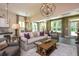 Open living space with stylish sofas, wood coffee table, hardwood floors, and lots of natural light at 170 Collared Dove Ct, Summerville, SC 29483