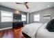 Cozy bedroom with light gray walls, hardwood floors, and a dark wood dresser with a TV at 182 E Bay St # 303, Charleston, SC 29401