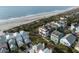 Aerial shot of beach neighborhood showcasing colorful homes with private yards and mature palm trees at 19 Grand Pavilion Blvd, Isle of Palms, SC 29451