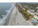 Panoramic aerial view captures a coastal community, sandy beaches, and the vast ocean horizon at 19 Grand Pavilion Blvd, Isle of Palms, SC 29451