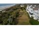 Tranquil backyard with lounge area showcases palm trees, direct beach access, and coastal home design at 19 Grand Pavilion Blvd, Isle of Palms, SC 29451