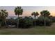 Tranquil backyard featuring palm trees and a hammock, with ocean views at 19 Grand Pavilion Blvd, Isle of Palms, SC 29451
