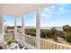 Balcony view of ocean with white columns and chairs at 19 Grand Pavilion Blvd, Isle of Palms, SC 29451