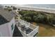 Relaxing ocean views can be enjoyed from the second-story balcony with rocking chairs on beautiful sunny day at 19 Grand Pavilion Blvd, Isle of Palms, SC 29451