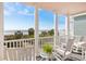 Serene balcony view of the ocean, sandy beach, and lush greenery at 19 Grand Pavilion Blvd, Isle of Palms, SC 29451