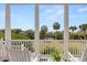 Relaxing balcony view showcasing lush greenery, palm trees, and the ocean beyond at 19 Grand Pavilion Blvd, Isle of Palms, SC 29451