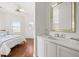 Bright bathroom leading into the bedroom features a vanity, mirror, and sleek white cabinets at 19 Grand Pavilion Blvd, Isle of Palms, SC 29451