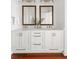 Bathroom vanity with double sinks, white cabinets and gold hardware at 19 Grand Pavilion Blvd, Isle of Palms, SC 29451