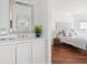 Well-lit bathroom adjacent to the bedroom features a vanity, mirror, and potted greenery at 19 Grand Pavilion Blvd, Isle of Palms, SC 29451