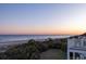 Enjoy serene beach views from this home, with palms and coastal landscape at 19 Grand Pavilion Blvd, Isle of Palms, SC 29451