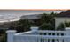A picturesque beach view from a home's deck, capturing ocean and coastline at 19 Grand Pavilion Blvd, Isle of Palms, SC 29451