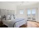 Bedroom with patterned headboard, ocean view, and wood floors at 19 Grand Pavilion Blvd, Isle of Palms, SC 29451