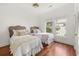 Bedroom with two beds, wood floors, ceiling fan and bright natural light at 19 Grand Pavilion Blvd, Isle of Palms, SC 29451
