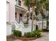 Lovely home exterior with well-maintained landscaping, stairs and a white picket fence at 19 Grand Pavilion Blvd, Isle of Palms, SC 29451