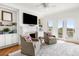 Cozy living room featuring comfortable seating, built-in bookshelves, and a fireplace with a TV above at 19 Grand Pavilion Blvd, Isle of Palms, SC 29451