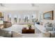 Bright, spacious living area with large windows, balcony access, and comfortable furniture at 19 Grand Pavilion Blvd, Isle of Palms, SC 29451