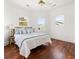 Sunny bedroom features white walls, hardwood floors, ceiling fan, and multiple windows at 19 Grand Pavilion Blvd, Isle of Palms, SC 29451
