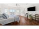 Bright bedroom boasts hardwood floors, beach views, and a ceiling fan for a cool, relaxing ambiance at 19 Grand Pavilion Blvd, Isle of Palms, SC 29451