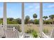Relaxing porch with comfortable seating and stunning views of lush greenery and the ocean at 19 Grand Pavilion Blvd, Isle of Palms, SC 29451