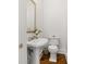 Classic powder room features a pedestal sink, toilet, and decorative mirror at 19 Grand Pavilion Blvd, Isle of Palms, SC 29451