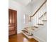 Elegant stairway with wooden steps, white risers, and a decorative banister at 19 Grand Pavilion Blvd, Isle of Palms, SC 29451