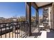 The home's balcony features dark railings, comfortable seating, and a great view of the city at 21 George St # 206, Charleston, SC 29401