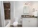 Bathroom featuring a bathtub, white toilet, and vanity with granite countertop and decorative mirror at 21 George St # 206, Charleston, SC 29401