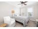 Well-lit bedroom with comfortable furniture, a ceiling fan, and natural light from two windows at 21 George St # 206, Charleston, SC 29401