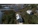 Aerial view of a modern house with a light gray roof surrounded by water and lush greenery at 2101 Guerins Bridge Rd, Wando, SC 29492