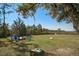 An expansive backyard, featuring lawn chairs around a fire pit, and a dock leading to the water at 2101 Guerins Bridge Rd, Wando, SC 29492