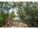 Secluded backyard featuring a kayak, trees and foliage, leading to water, a perfect blend of nature and adventure at 2101 Guerins Bridge Rd, Wando, SC 29492