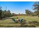 Spacious backyard featuring a fire pit with Adirondack chairs offering a perfect setting for outdoor gatherings at 2101 Guerins Bridge Rd, Wando, SC 29492