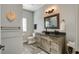 Elegant bathroom featuring a framed mirror, bronze fixtures, and ample vanity storage for a stylish and functional design at 2101 Guerins Bridge Rd, Wando, SC 29492