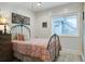 Well-lit bedroom with wood plank walls, a metal bed frame, natural light, and tasteful decor at 2101 Guerins Bridge Rd, Wando, SC 29492