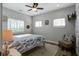 Comfortable bedroom boasts natural light, a ceiling fan, and charming decor for a welcoming ambiance at 2101 Guerins Bridge Rd, Wando, SC 29492