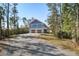 Exterior view of the home featuring an attached two-car garage and blue siding at 2101 Guerins Bridge Rd, Wando, SC 29492
