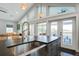 Modern kitchen featuring a stainless steel sink, custom cabinetry, and a kitchen island with barstool seating at 2101 Guerins Bridge Rd, Wando, SC 29492