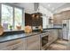 Beautiful kitchen with stainless steel appliances, dark countertops and wood cabinets at 2101 Guerins Bridge Rd, Wando, SC 29492