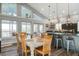 Open-concept kitchen and dining area featuring a large island, stainless steel appliances, and views of the marsh at 2101 Guerins Bridge Rd, Wando, SC 29492