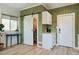 Compact kitchenette area featuring modern cabinetry, a sliding barn door, and wood plank accent walls at 2101 Guerins Bridge Rd, Wando, SC 29492
