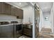 Functional laundry room features a modern washer and dryer, a farmhouse sink, and a rustic barn door at 2101 Guerins Bridge Rd, Wando, SC 29492