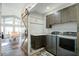Convenient laundry room with modern washer and dryer, stylish cabinets, and a sliding barn door at 2101 Guerins Bridge Rd, Wando, SC 29492