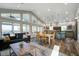 Open-concept living space featuring a modern kitchen, dining area, and comfortable seating, with scenic outdoor views at 2101 Guerins Bridge Rd, Wando, SC 29492