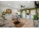 Inviting living room features a ceiling fan, comfortable seating, wood plank walls, and modern decor at 2101 Guerins Bridge Rd, Wando, SC 29492