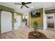 Charming living area featuring wood plank walls, a ceiling fan, modern kitchenette, and an open layout at 2101 Guerins Bridge Rd, Wando, SC 29492