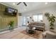 Cozy living room with wood plank accent walls, a ceiling fan, plush seating, and access to the outdoors at 2101 Guerins Bridge Rd, Wando, SC 29492