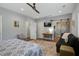 Comfortable main bedroom with TV, a barn door to the ensuite bathroom, and a decorative rug at 2101 Guerins Bridge Rd, Wando, SC 29492